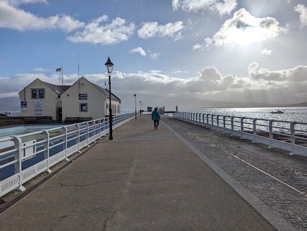 Beaumaris Pier with the RNLI lifeboat station and lifeboat on the water