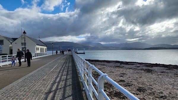 Beaumaris Pier stretching out into the Menai Strait at low tide